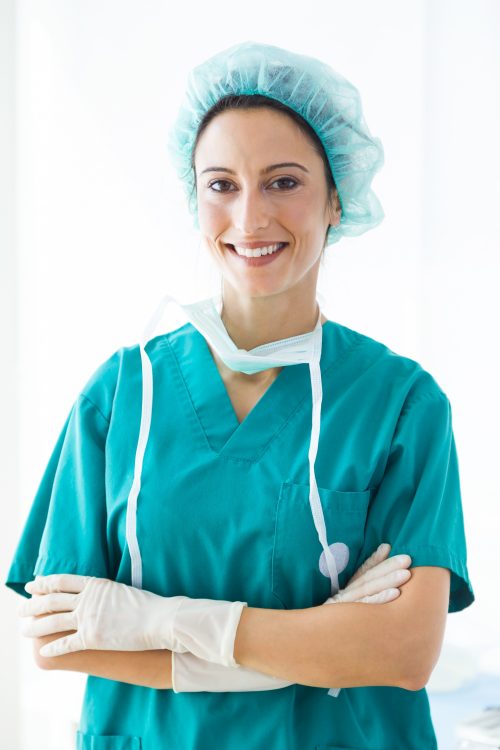 confident-female-medical-worker-wearing-hat-and-mask-looking-to-the-camera